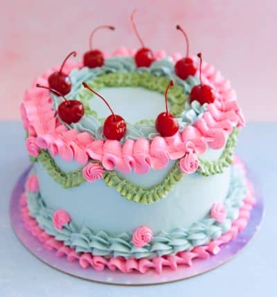 rainbow vintage piped cake with cherries