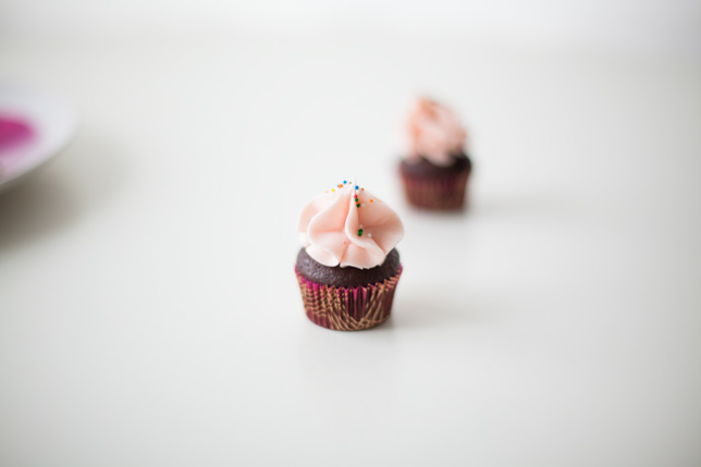 mini cupcake with ruffle pink frosting on table