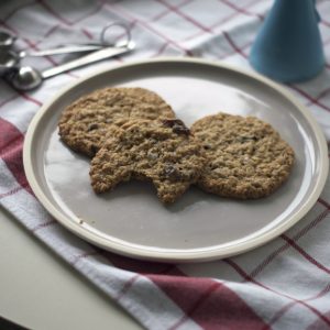 oatmeal raisin cookies on a plate on tablecloth