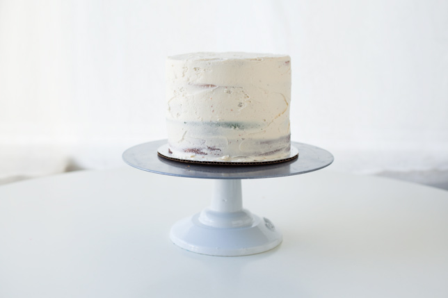 cake with white icing on stand