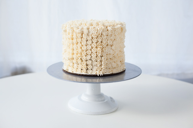 cake with white icing on stand