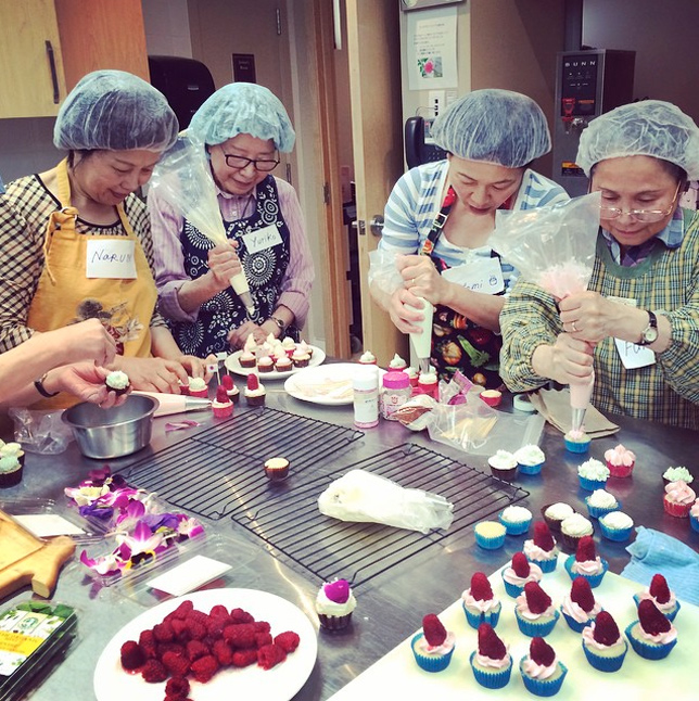 japanese seniors making cupcakes