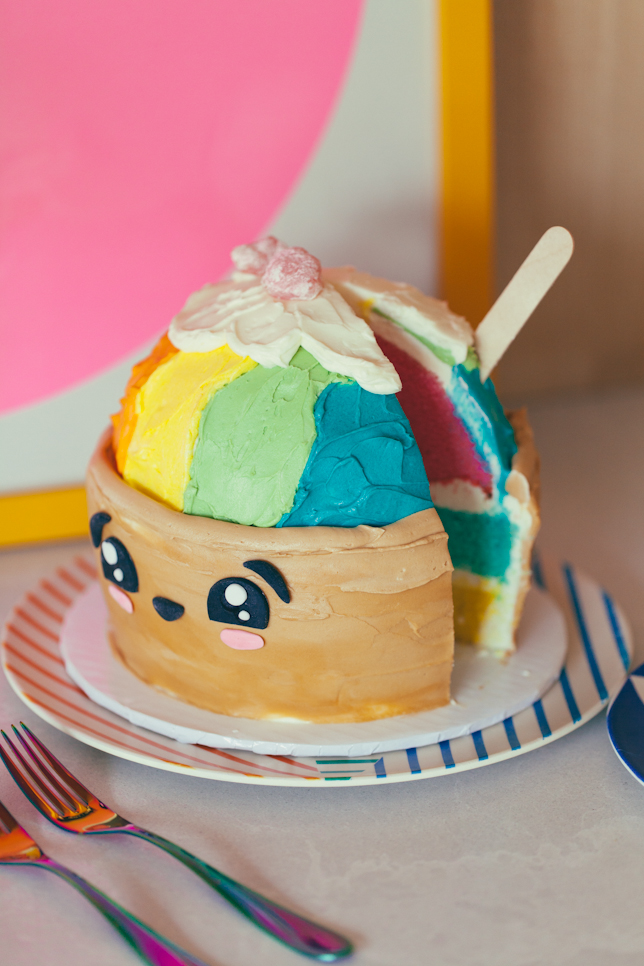 Rainbow cake layer surprise insides of a shave ice themed buttercream cake