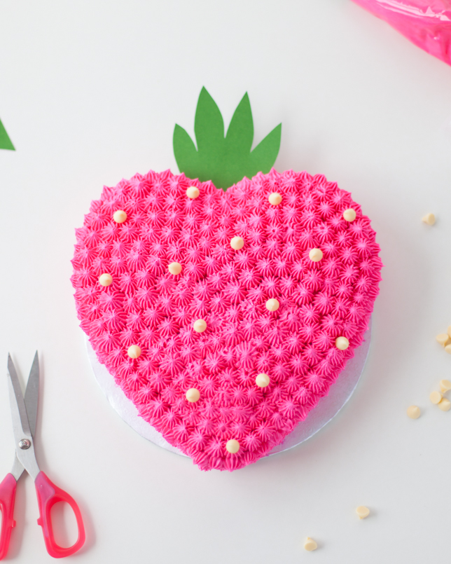 strawberry heart cake with chocolate chips overhead view