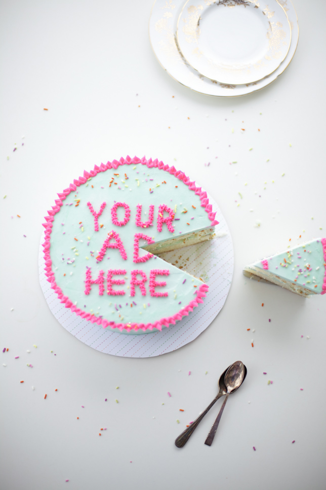 green cake with pink lettering and slice of cake